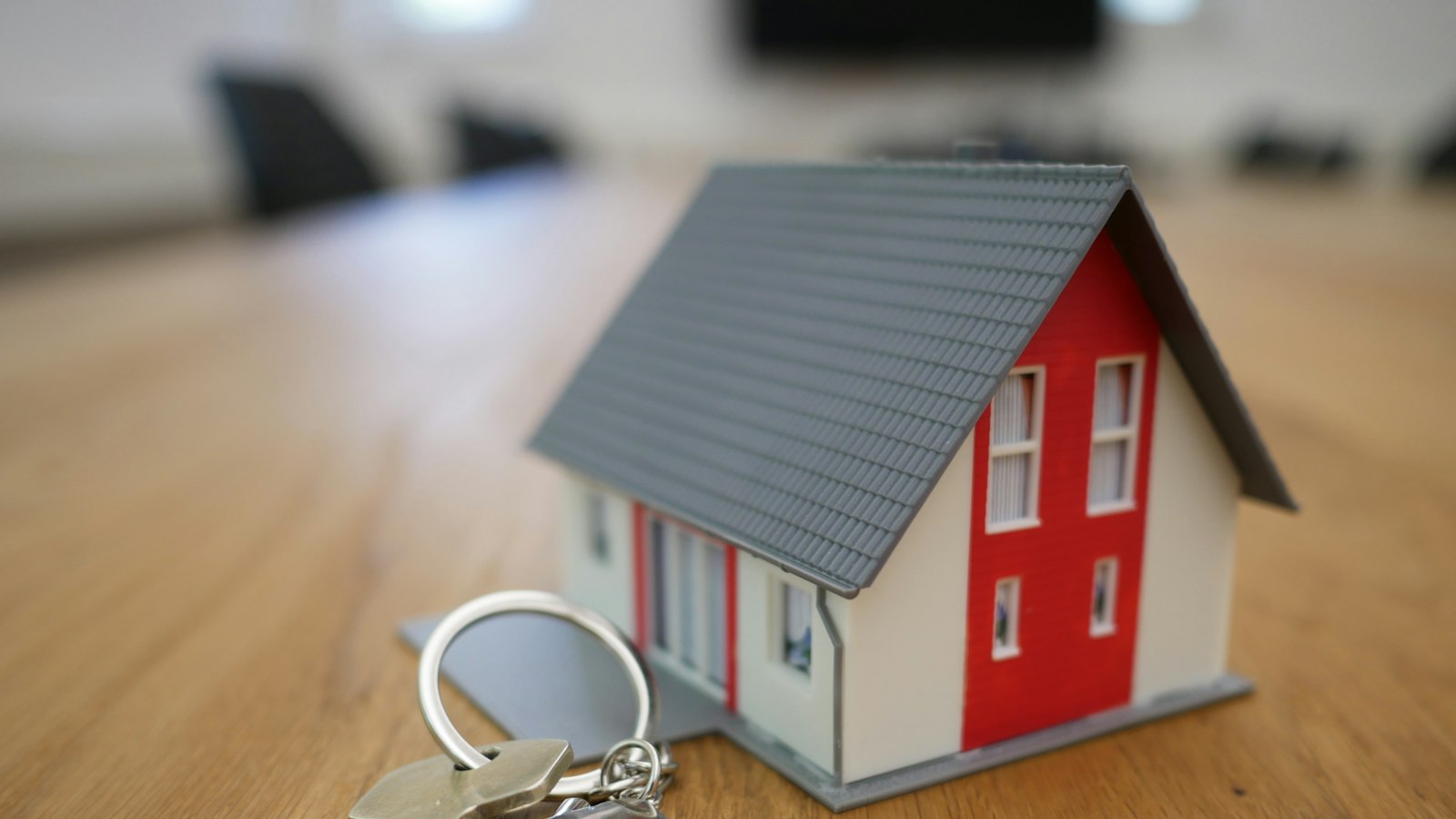 Miniatura de casa e chaves sobre a mesa